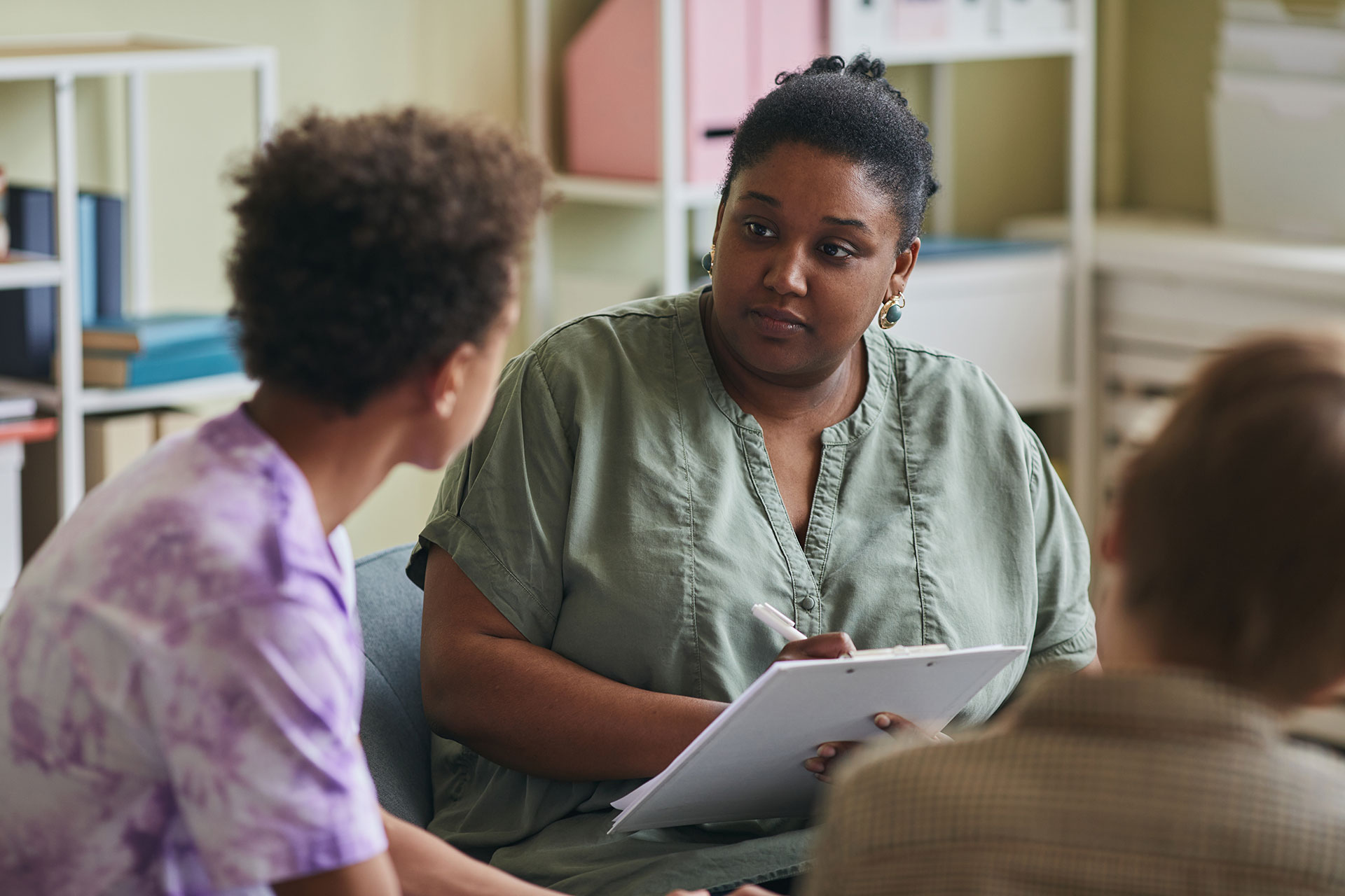 Psychologist in her office talking to a youth